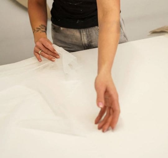 artisan upholsterer working with fabric in MEK Design workshop
